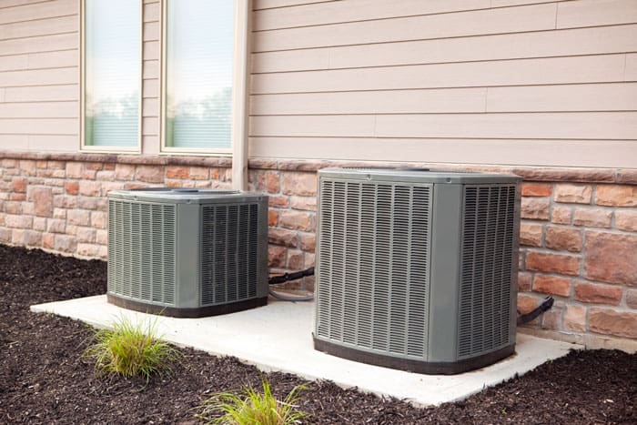 2 Residential AC units on concrete slabs 